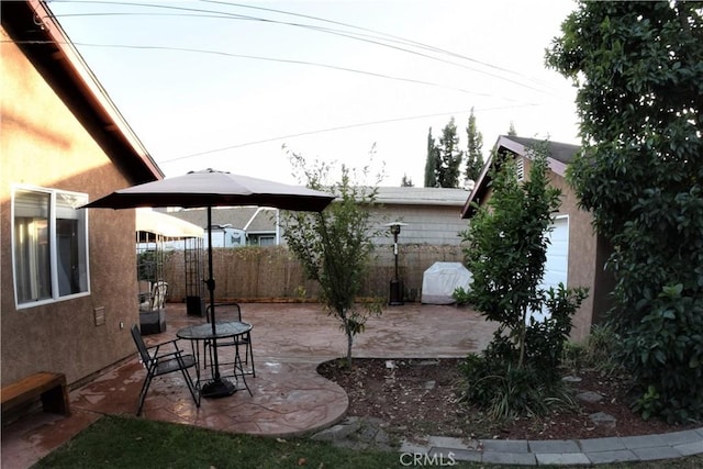 view of yard with fence and a patio