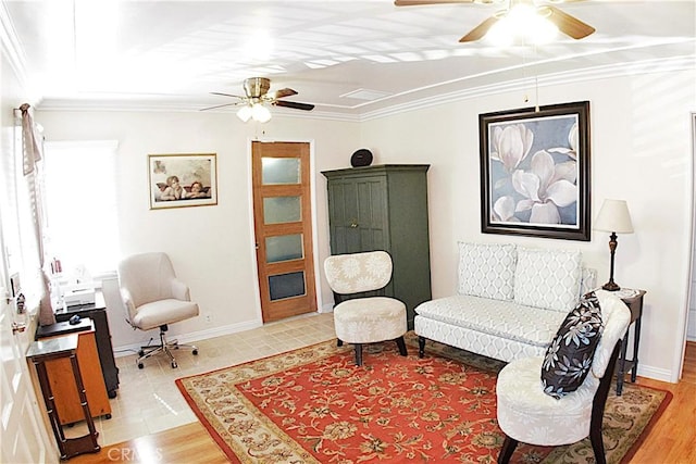 living area with ceiling fan, light wood finished floors, baseboards, and crown molding