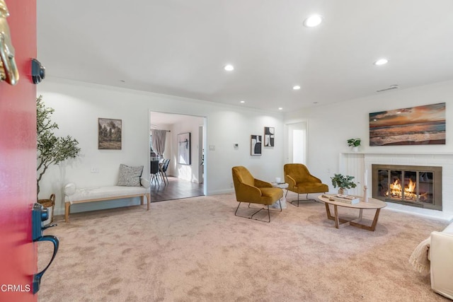 carpeted living room with a glass covered fireplace, recessed lighting, and baseboards