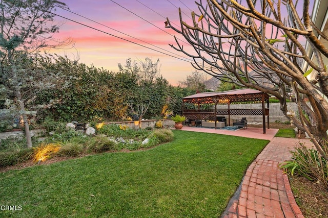 view of yard featuring a gazebo, fence, and a patio area