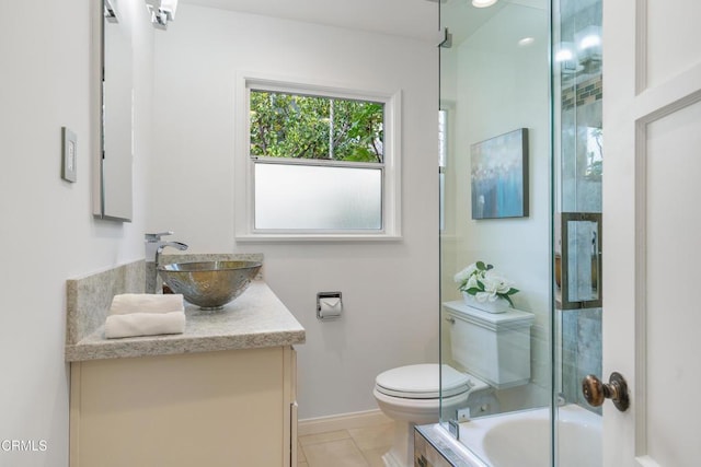 full bathroom with tile patterned flooring, baseboards, toilet, enclosed tub / shower combo, and vanity