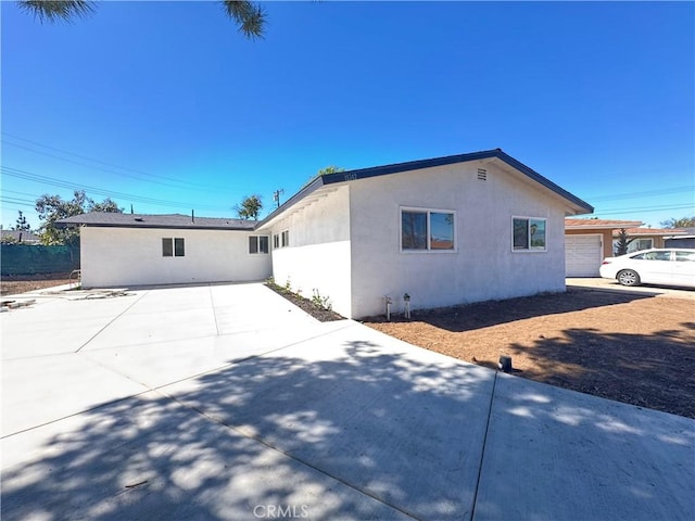 view of property exterior with a patio and stucco siding