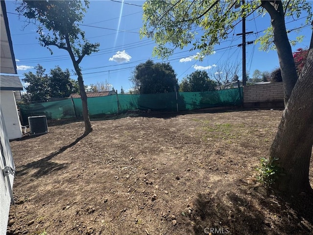 view of yard with a fenced backyard and central air condition unit