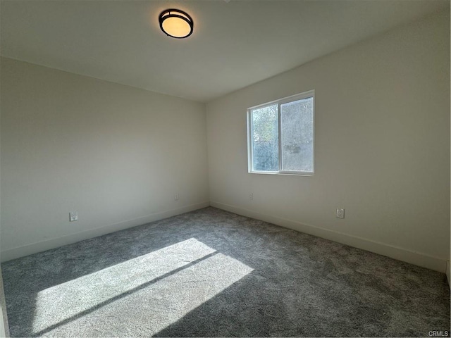 spare room with carpet floors and baseboards