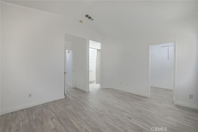 spare room with light wood-style floors, baseboards, and visible vents