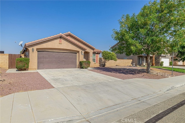 ranch-style house featuring a garage, a tiled roof, concrete driveway, and stucco siding