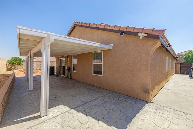 exterior space with a patio and stucco siding