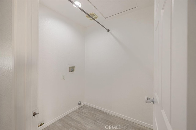 laundry room with laundry area, baseboards, washer hookup, and light wood finished floors