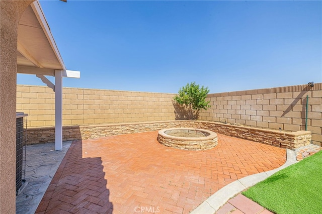 view of patio / terrace with a fenced backyard and a fire pit