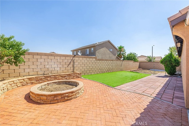 view of patio / terrace with a fire pit and a fenced backyard