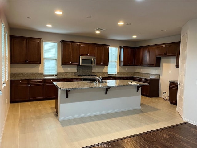 kitchen featuring a wealth of natural light, visible vents, appliances with stainless steel finishes, and a sink