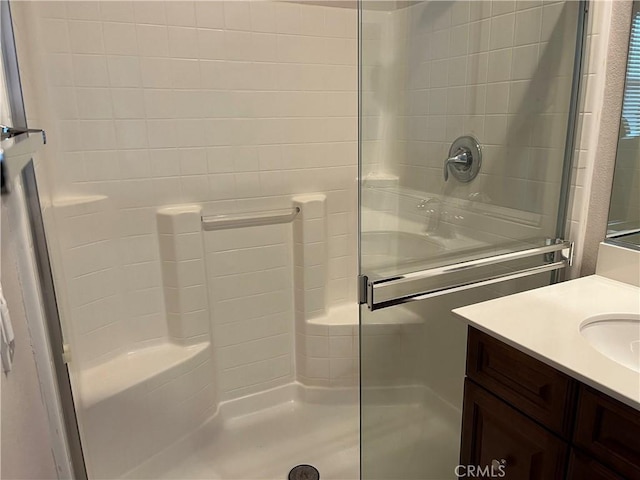 bathroom featuring walk in shower and vanity