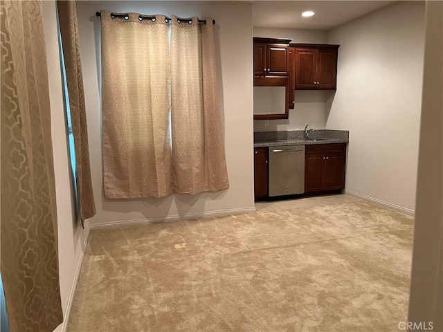 kitchen with baseboards, light colored carpet, dark stone countertops, stainless steel dishwasher, and recessed lighting