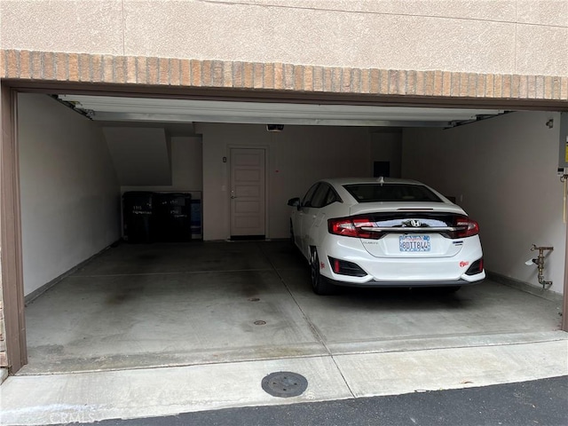 garage featuring baseboards and a garage door opener