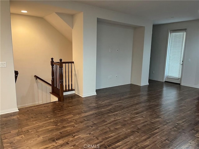 unfurnished room with baseboards, dark wood finished floors, and recessed lighting