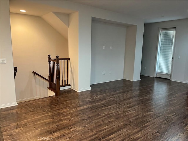 spare room featuring baseboards, dark wood finished floors, and recessed lighting