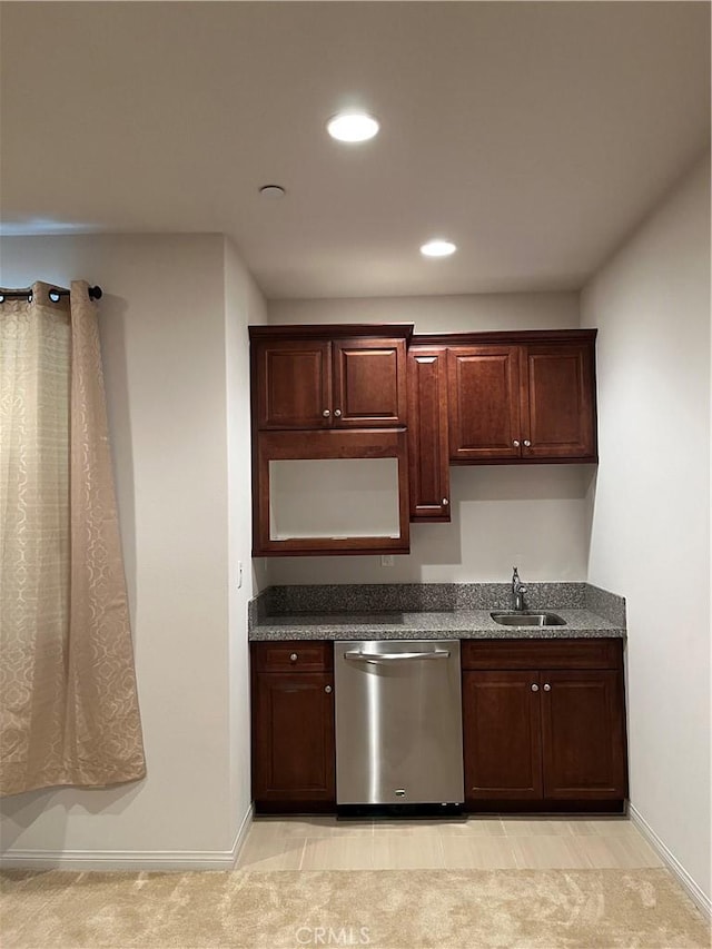 kitchen featuring recessed lighting, baseboards, dishwasher, and a sink