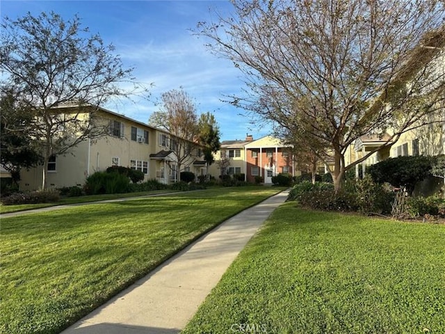 view of community with a residential view and a lawn