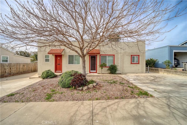 view of front of property with fence and stucco siding