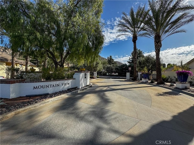 view of street featuring curbs and a gated entry