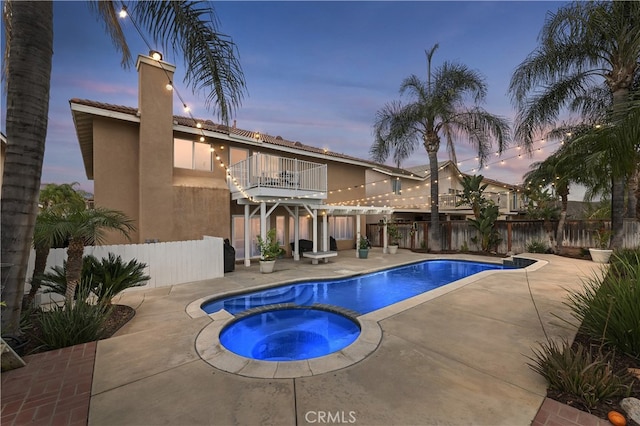 view of pool with a fenced in pool, a patio area, fence, and an in ground hot tub