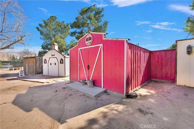 view of shed featuring fence