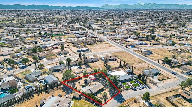 drone / aerial view featuring a residential view and a mountain view