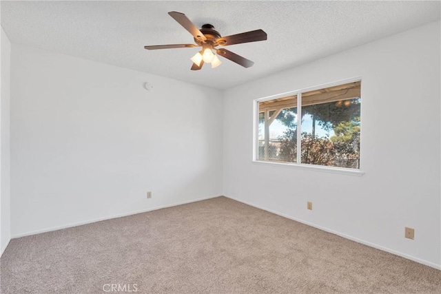 empty room with carpet floors, ceiling fan, and a textured ceiling