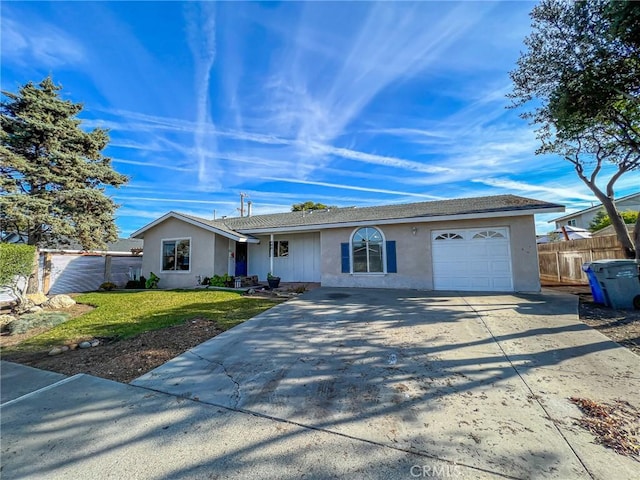 ranch-style home with an attached garage, fence, driveway, stucco siding, and a front lawn