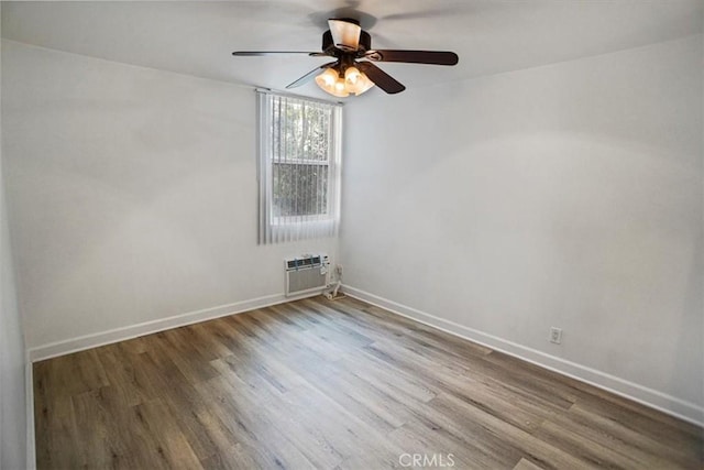 unfurnished room featuring baseboards and wood finished floors