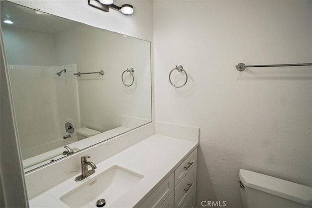 bathroom featuring shower / bathing tub combination, vanity, and toilet