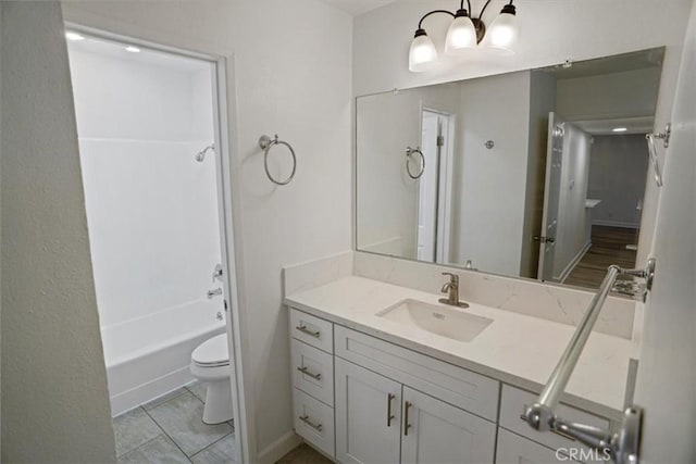 bathroom featuring toilet, shower / bathtub combination, and vanity