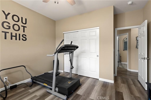 workout area with ceiling fan, wood finished floors, and baseboards