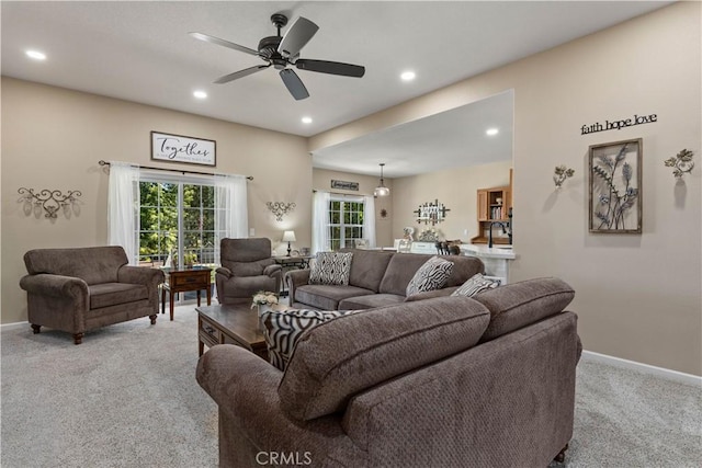 living area featuring recessed lighting, baseboards, a ceiling fan, and light colored carpet