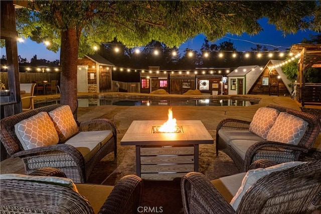 view of patio featuring an outdoor living space with a fire pit