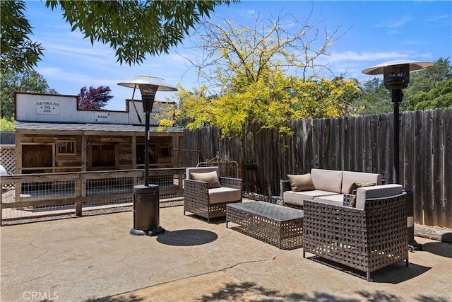 view of patio featuring fence and an outdoor living space