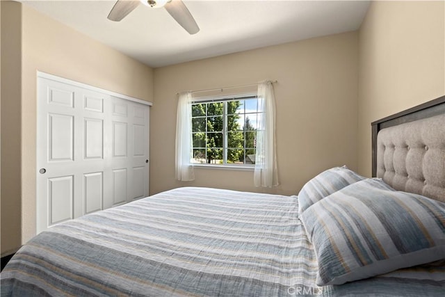 bedroom with ceiling fan and a closet