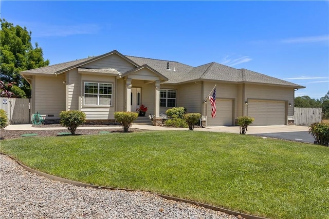 view of front of home featuring concrete driveway, a front lawn, an attached garage, and fence