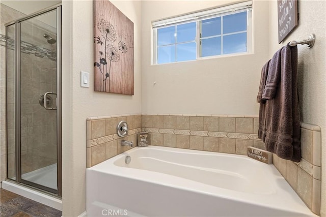 full bath with a stall shower and a garden tub