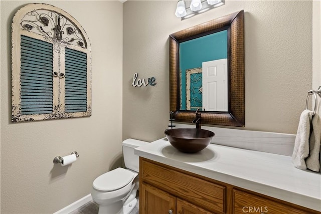 bathroom with toilet and vanity