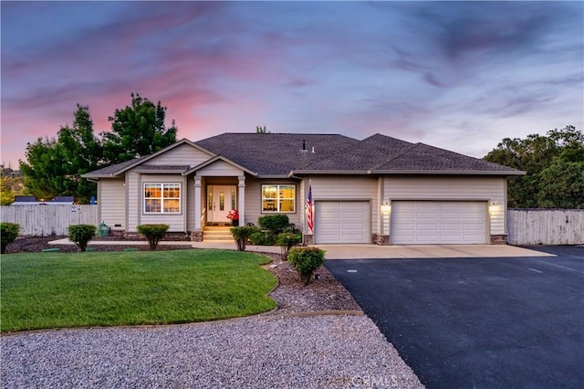 single story home with driveway, a garage, fence, and a lawn