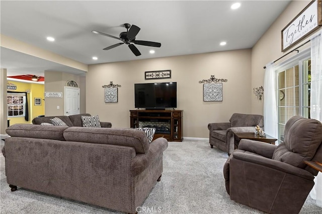 carpeted living room with ceiling fan, baseboards, and recessed lighting