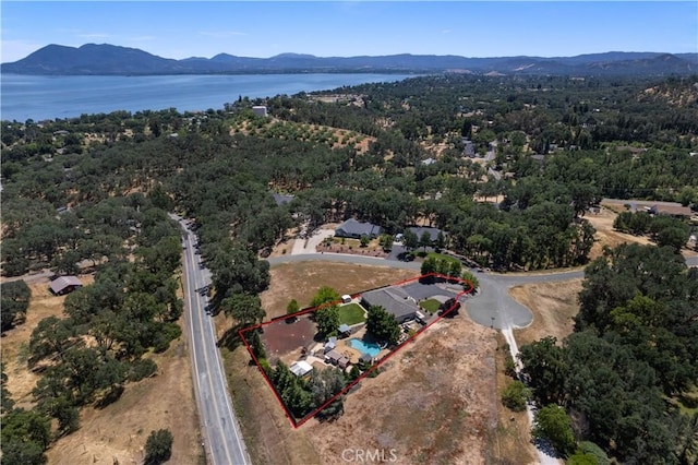 drone / aerial view featuring a water and mountain view