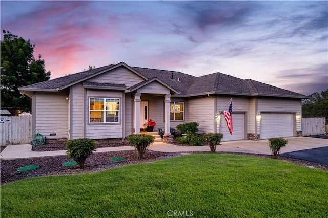 ranch-style home with driveway, a front lawn, a garage, and fence