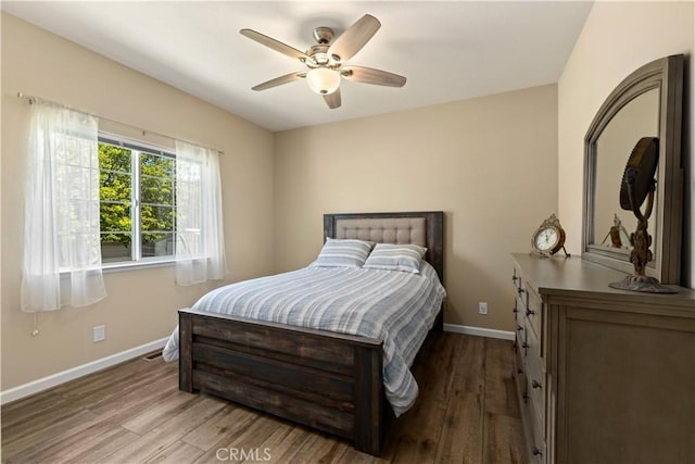 bedroom with ceiling fan, baseboards, and wood finished floors