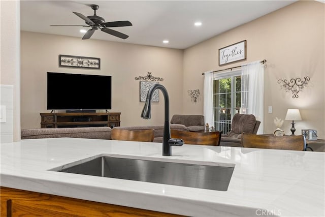 room details with a ceiling fan, recessed lighting, and a sink