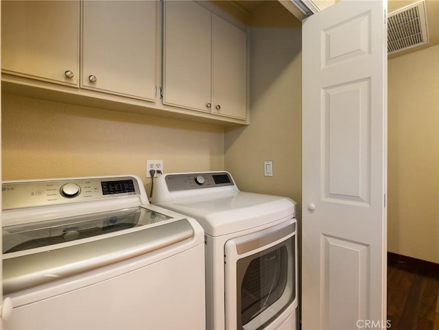 laundry room with laundry area, wood finished floors, visible vents, baseboards, and washer and dryer