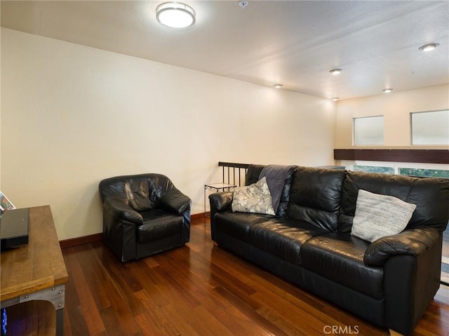 living area featuring baseboards and wood finished floors