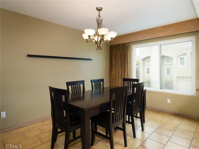 dining room featuring baseboards, light tile patterned flooring, and a notable chandelier