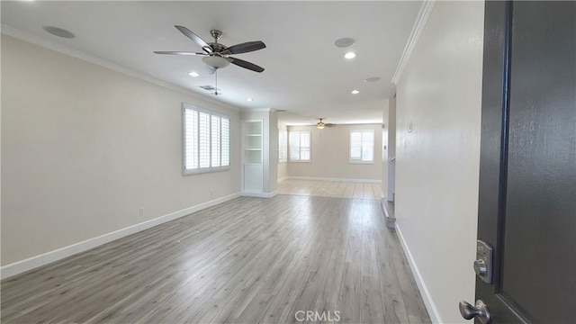 empty room featuring recessed lighting, visible vents, baseboards, ornamental molding, and light wood-type flooring